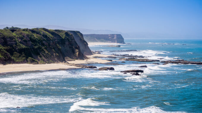 Cliffs and sandy beach on the Pacific Ocean coastline near Half Moon Bay, California
