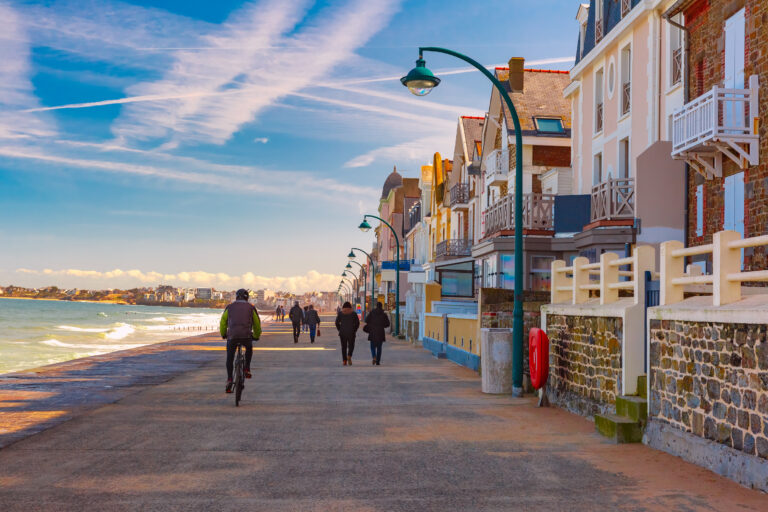 High stone embankment at hide tide, in beautiful walled port city of Privateers Saint-Malo, also known as city corsaire, Brittany, France.