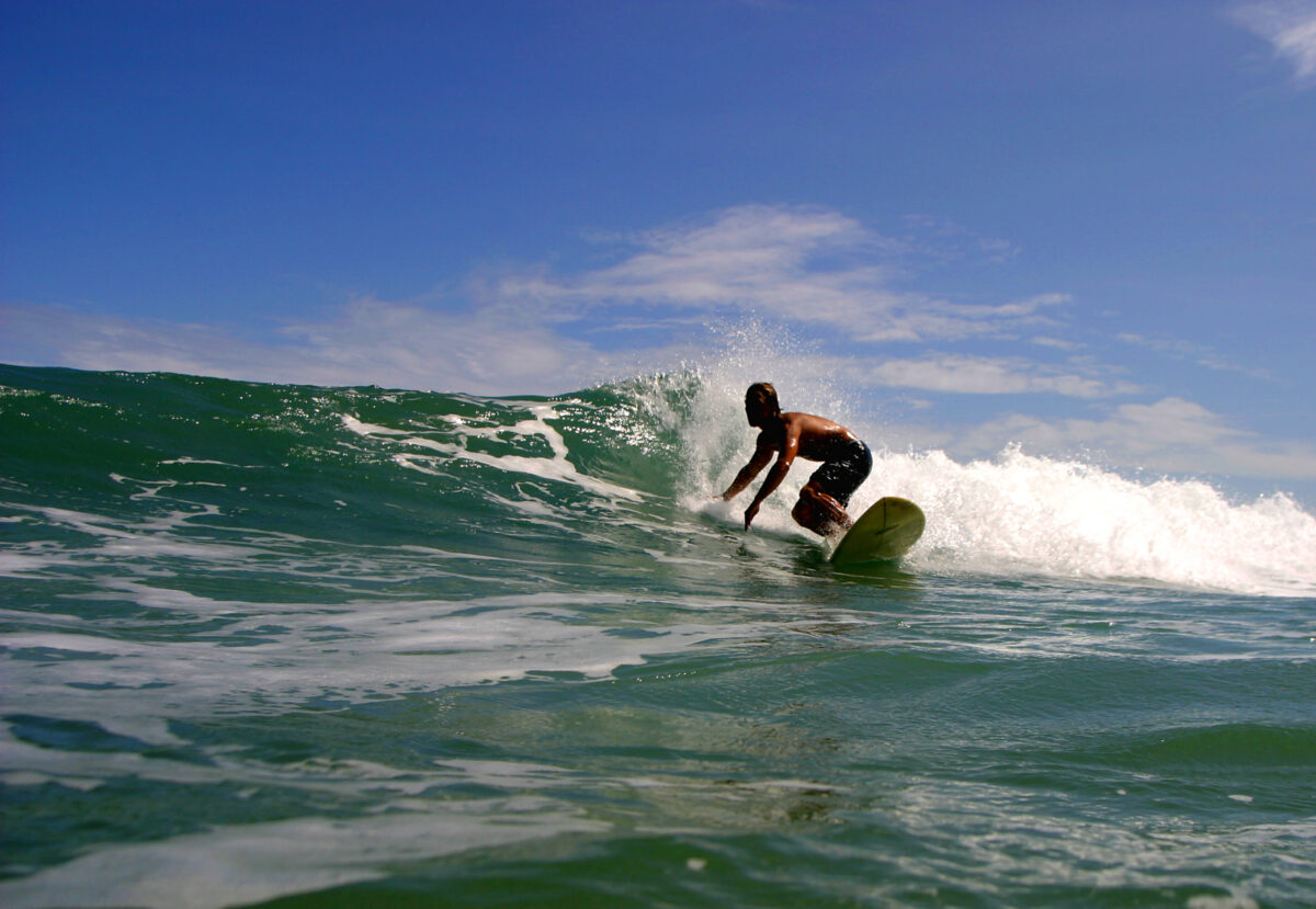 A surfer riding a wave in Puerto Viejo, Costa Rica.