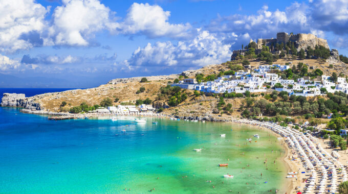 Panoramic view of Lindos bay, village and Acropolis, Rhodes, Greece.