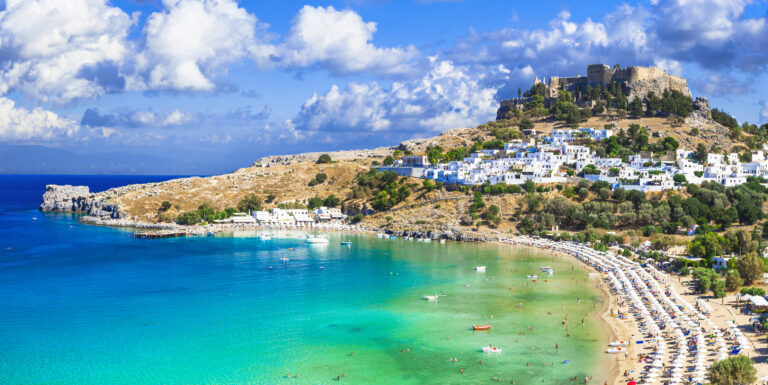 Panoramic view of Lindos bay, village and Acropolis, Rhodes, Greece.
