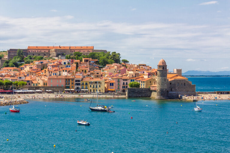 Tourists enjoy the beach of Collioure, coastal village in the south of France, Mediterranean sea, Languedoc Roussillon, Pyrenees Orientales.