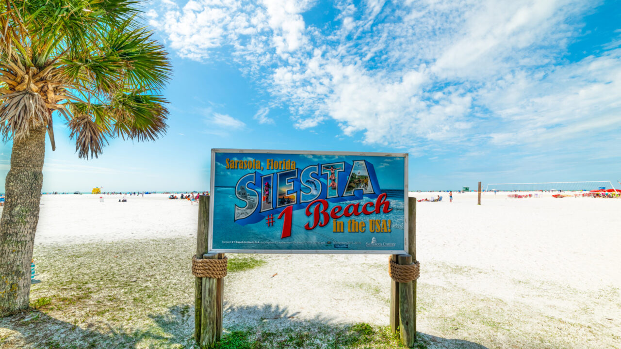 Siesta Beach sign on a clear day.