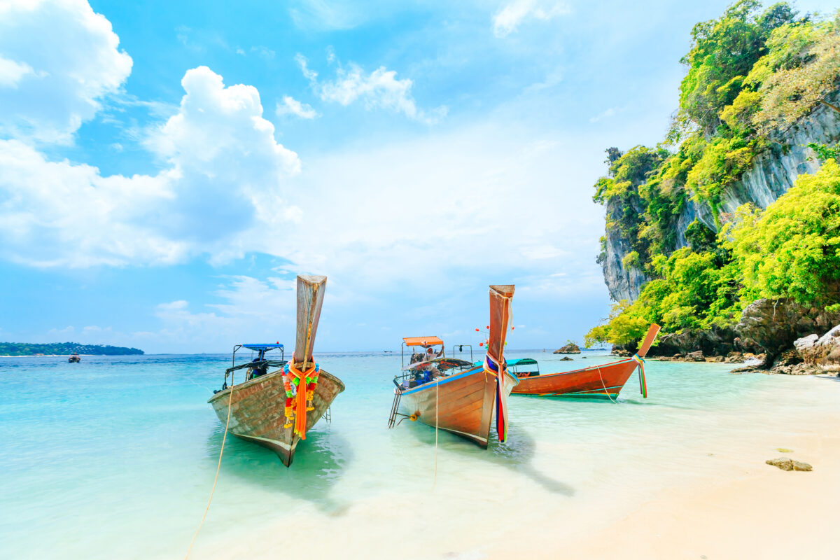 Longtale boat on the white beach at Phuket, Thailand. Phuket is a popular destination famous for its beaches.