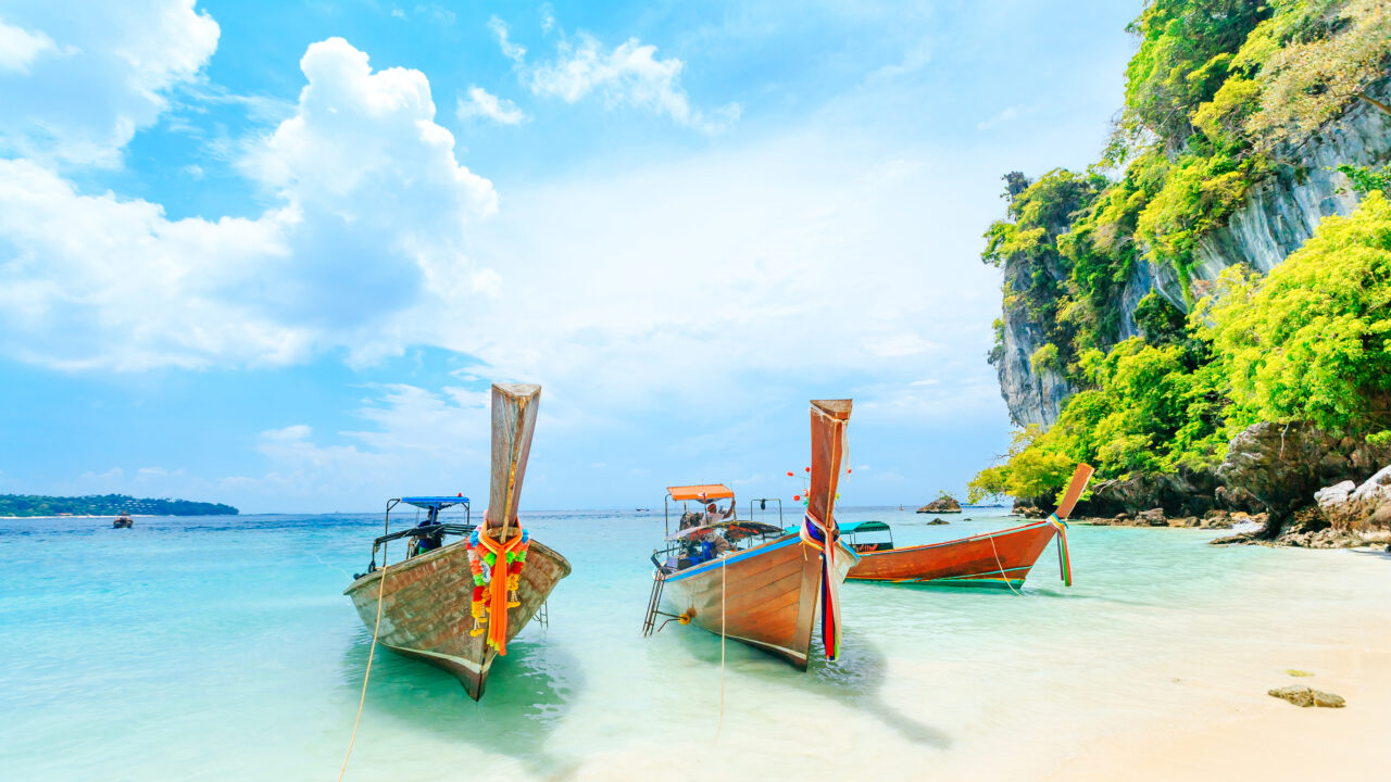 Longtale boat on the white beach at Phuket, Thailand. Phuket is a popular destination famous for its beaches.