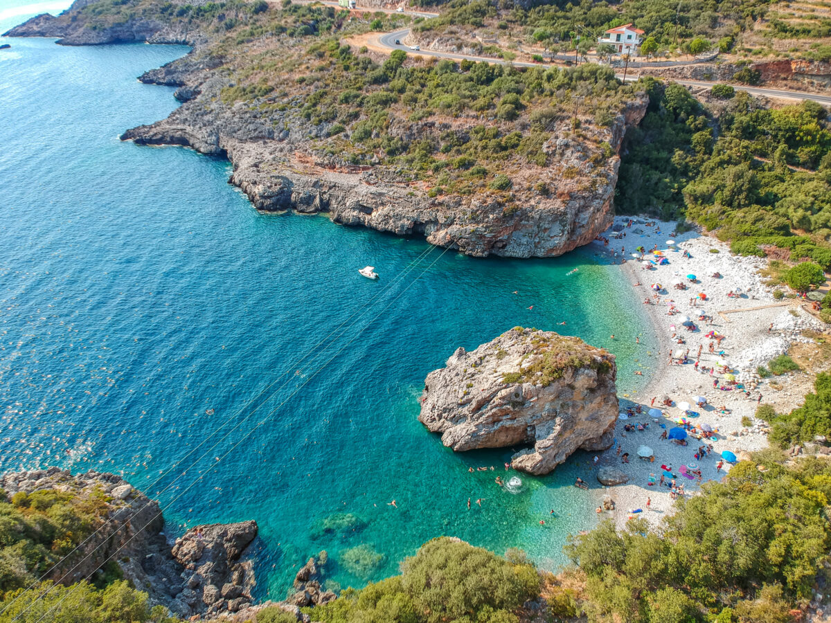Aerial view of the famous rocky beach Foneas near Kardamyli village in the seaside Messenian Mani area during high tourist Summer period. Messenia Peloponnese Greece Europe