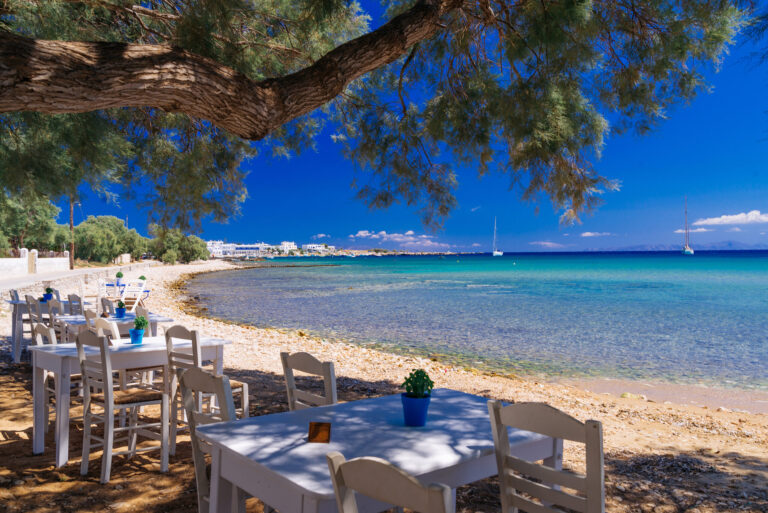Cute little tavern in the olive shade on Paros island, cycladic paradise resort, Cyclades, Greece.