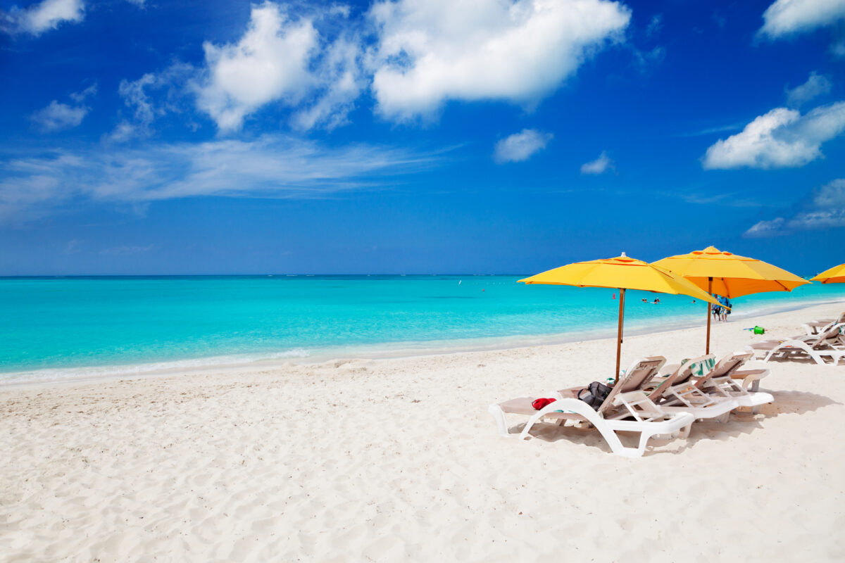 Chairs & yellow umbrellas on Grace Bay Beach.