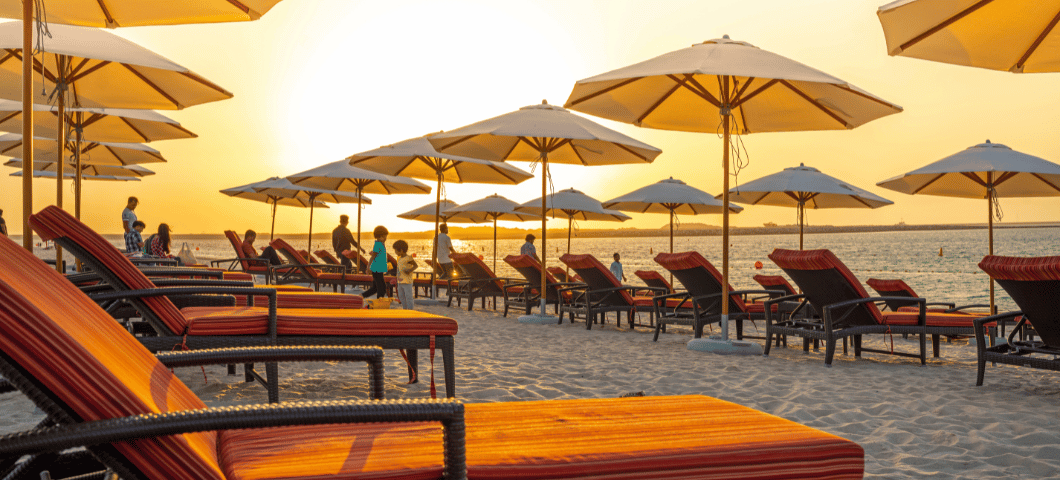 Dubai Islands Beach by Dubai Retail sunset with beach umbrellas