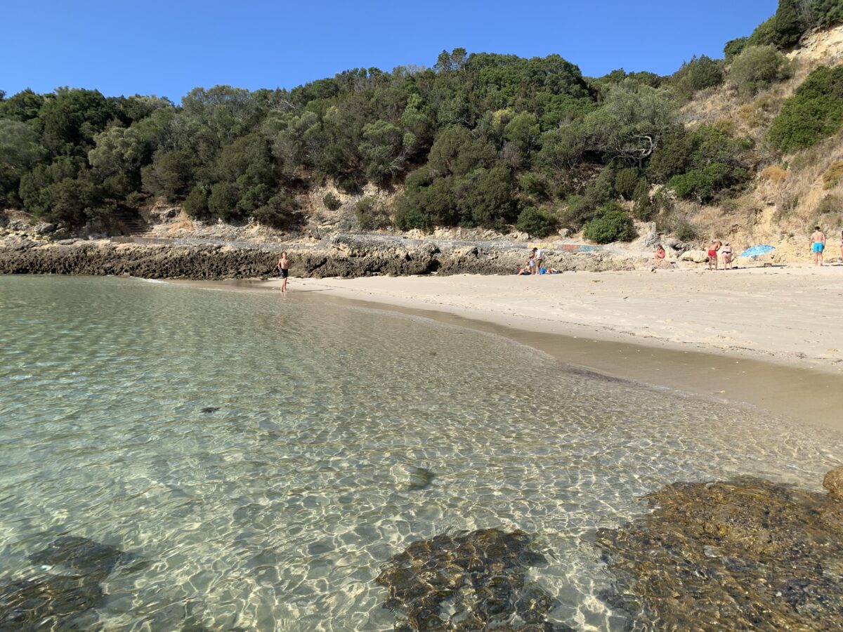 beach with crystal clear water in setubal, portugal