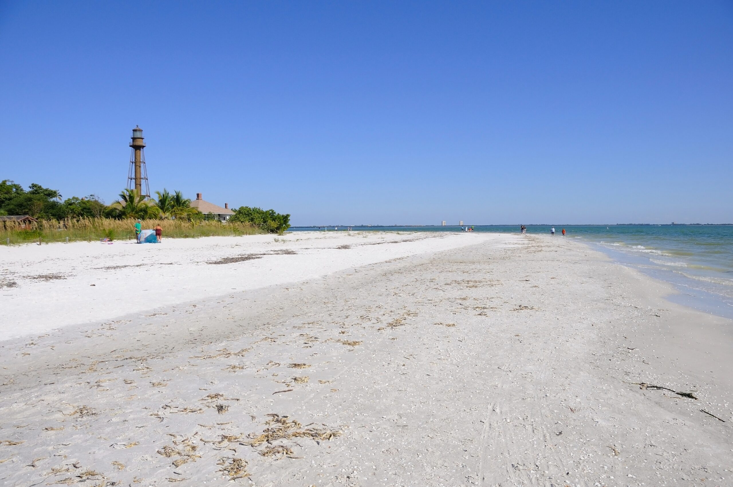 Sanibel Island Sandy Coast. Long beach and distant lighthouse on Sanibel Island in Florida