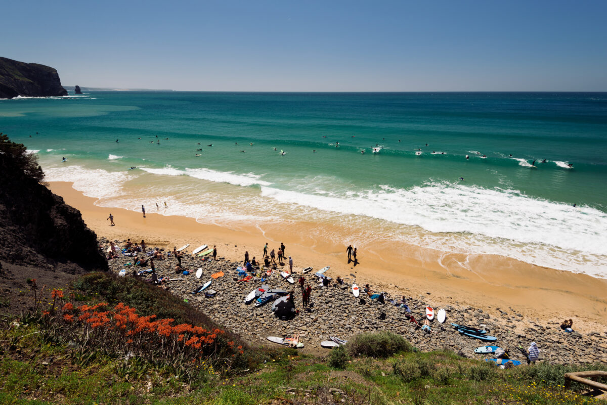 Surfers gather at the Arrifana Beach in Aljezur, Algarve, Portugal.