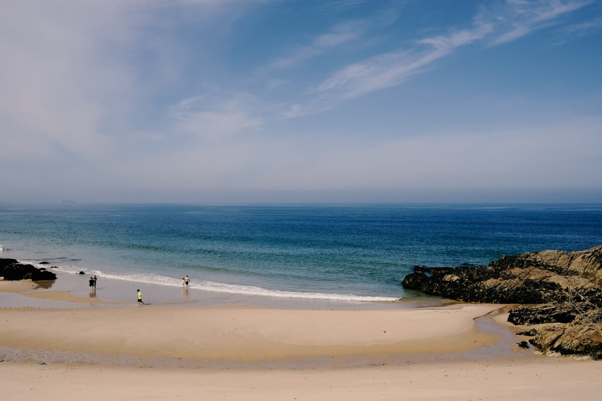 Seascape LeÃ§a da Palmeira, Porto, Portugal. Praia Leca da Palmeira,Matosinhos Portugal. Blue ocean and sky as background. Some people play on the sand.