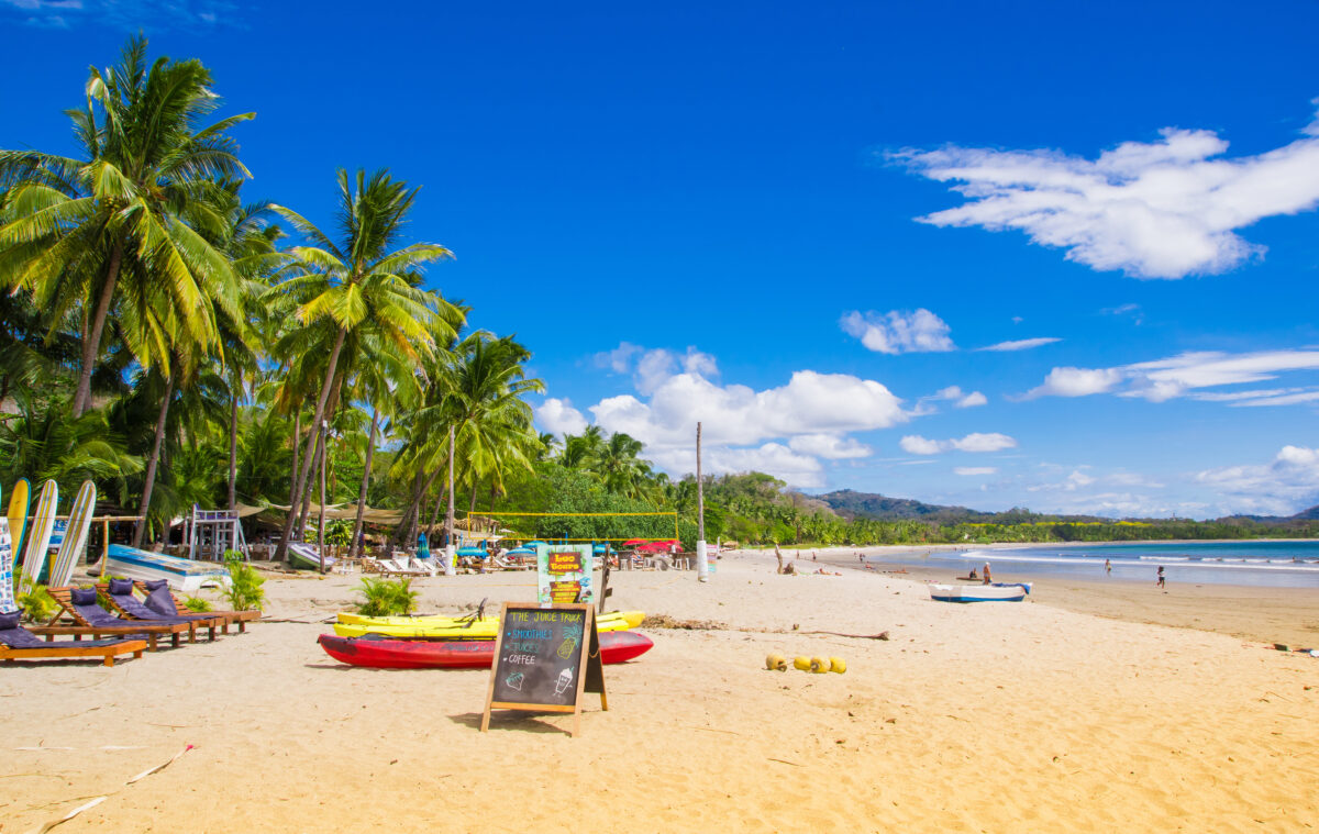 Outdoor view of colorful kayaks on the tropical beach of Samara, Costa Rica.
