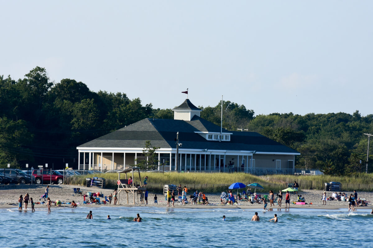 Vacationers enjoy the cool ocean water at Town Beach in Narragansett, Rhode Island.