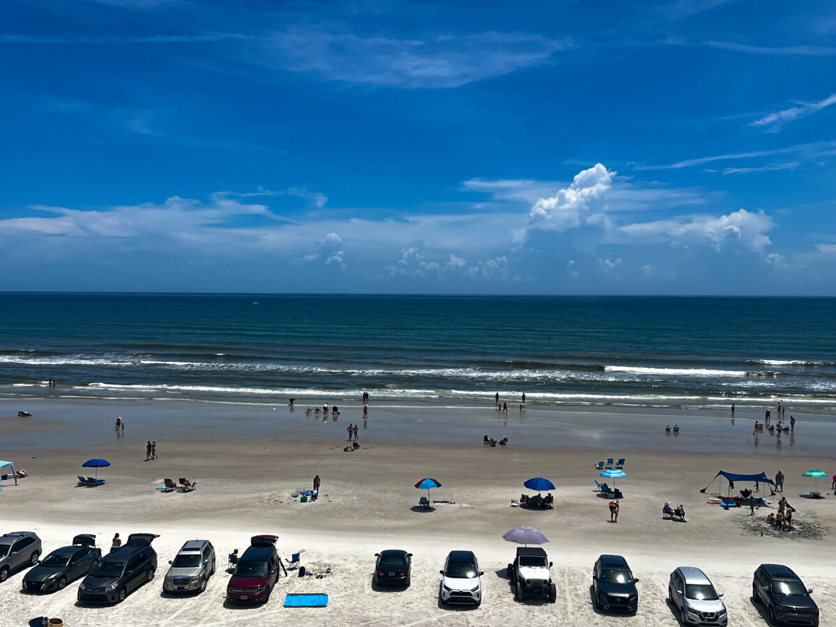 Cars and people on the beach in New Smyrna Beach.