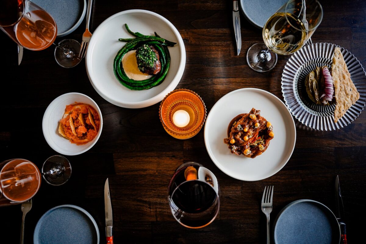 table full of plated food at Rooster and the Till — Tampa