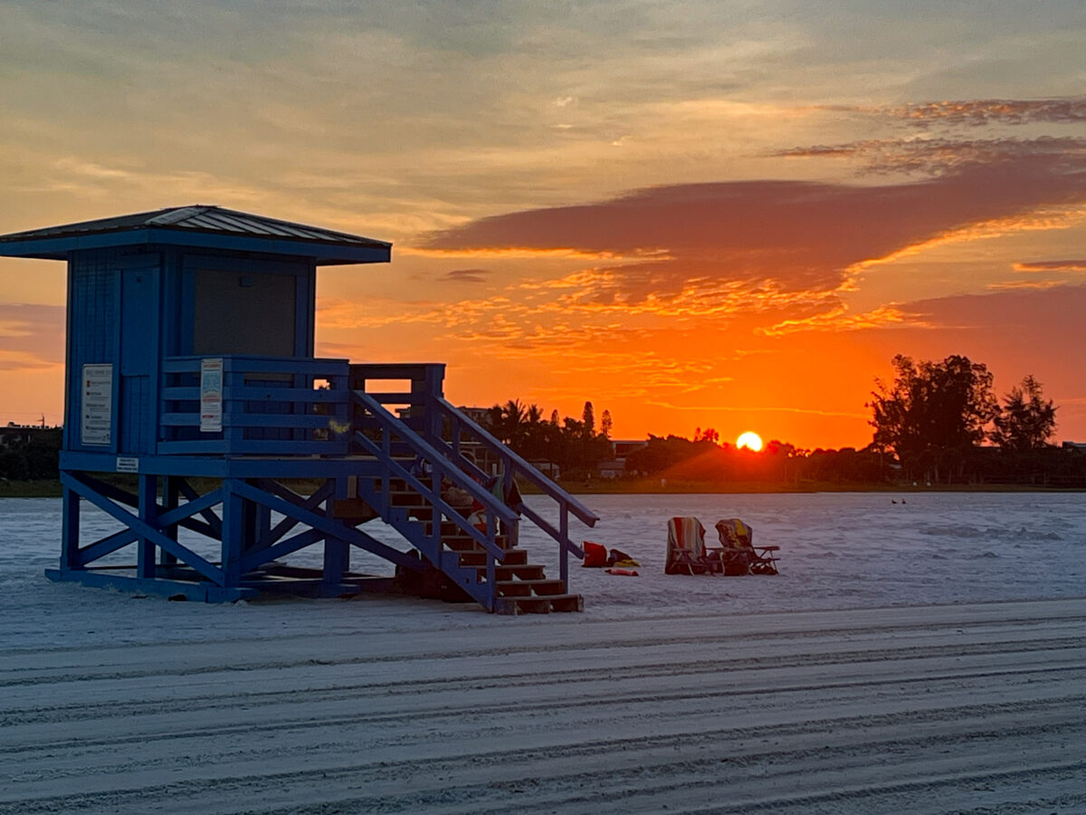 Lifeguard Stand, chairs, and sunrise in Siesta Key FL