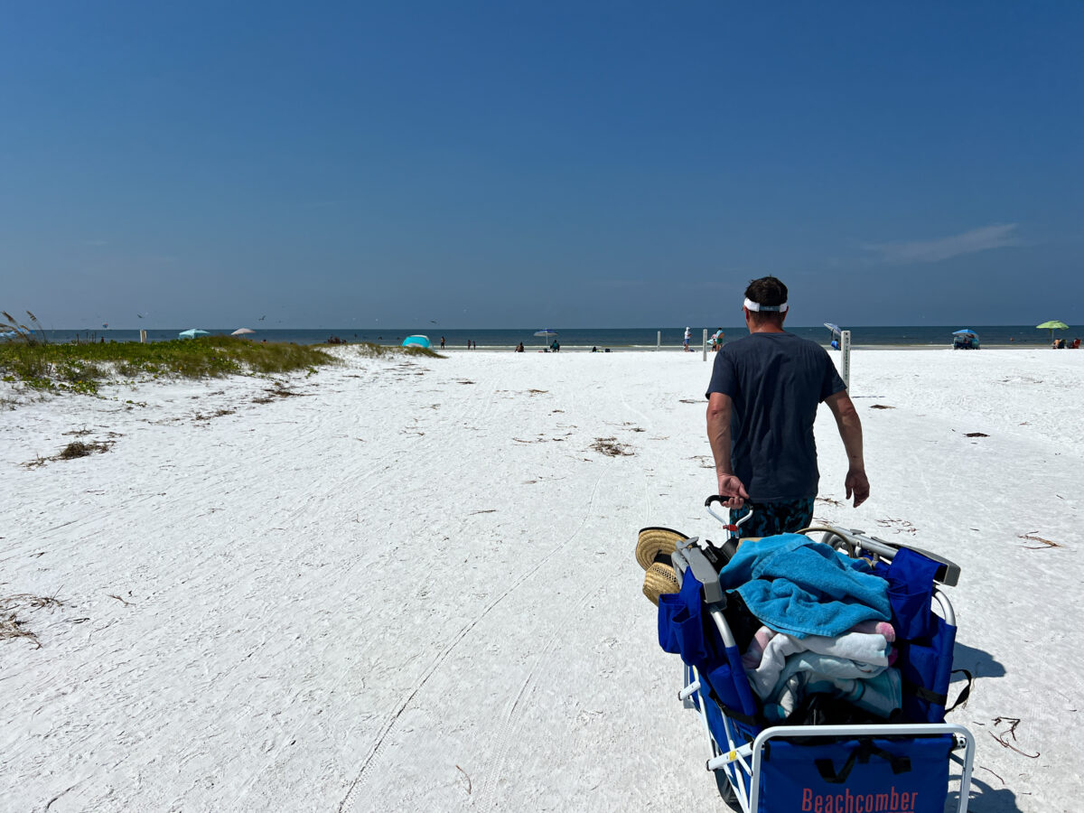 Pulling beach buggy across white sand in Siesta Key FL