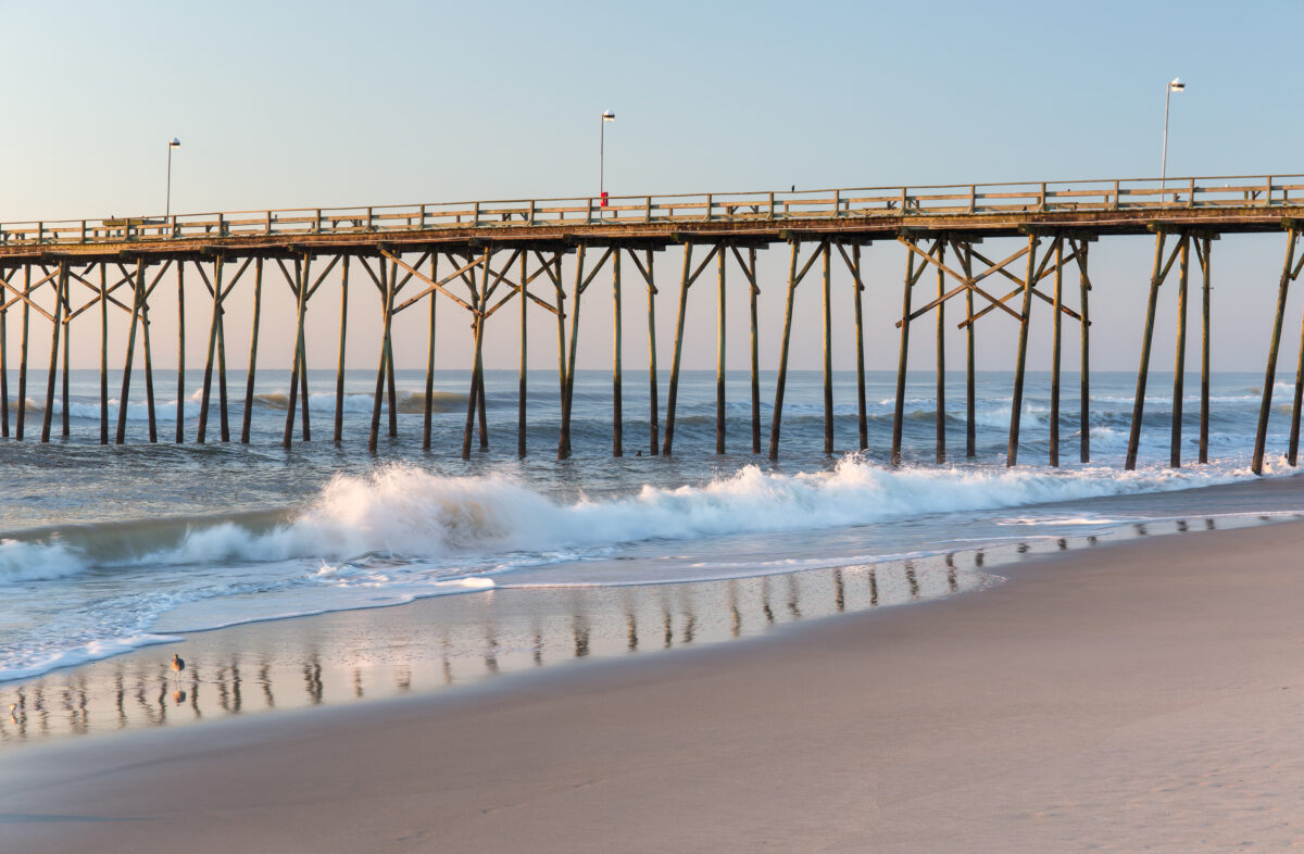 Fishing pier and waves at Kure Beach, North Carolina.