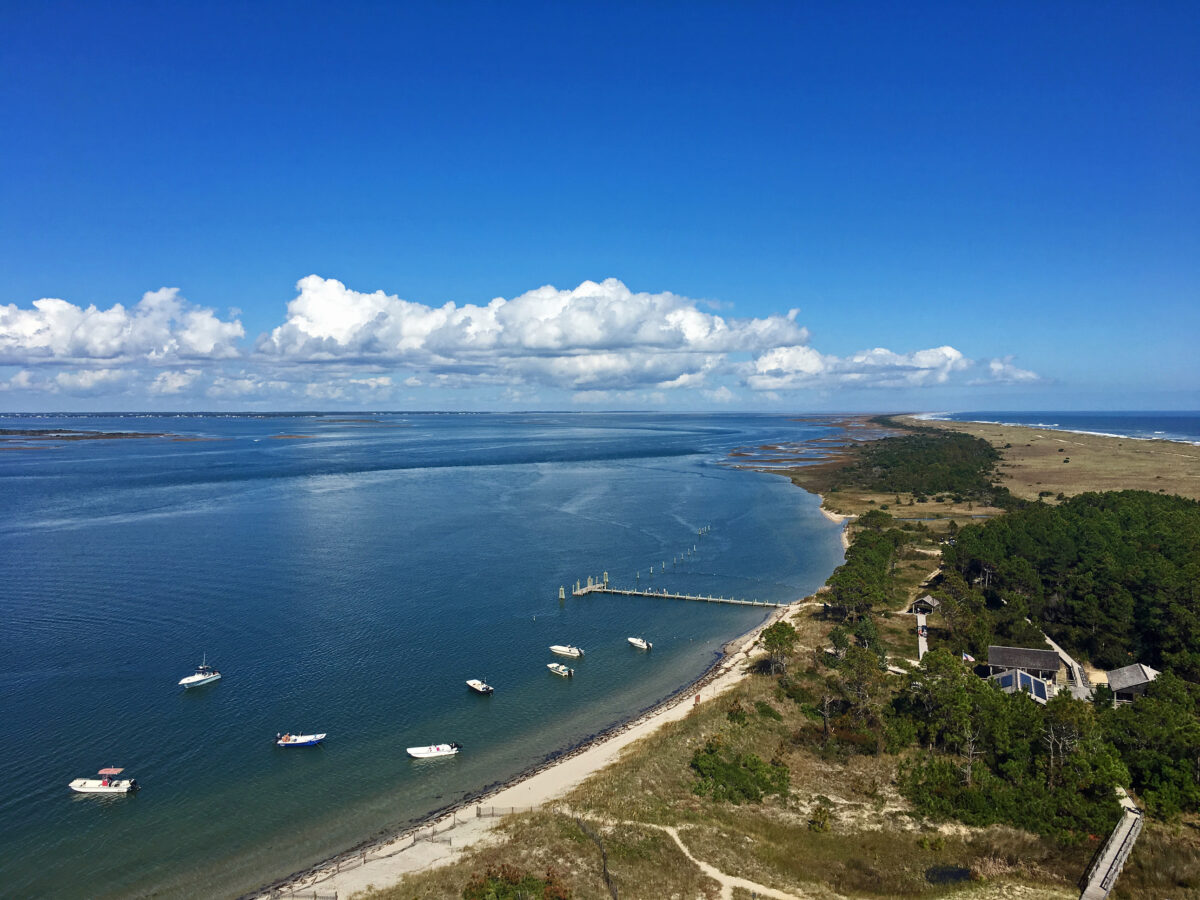 Aerial view of Cape Lookout National Seashore, North Carolina. From a bird`s eye view, boats dot the ocean and land stretches as the eye can see over Cape Lookout National seashore.