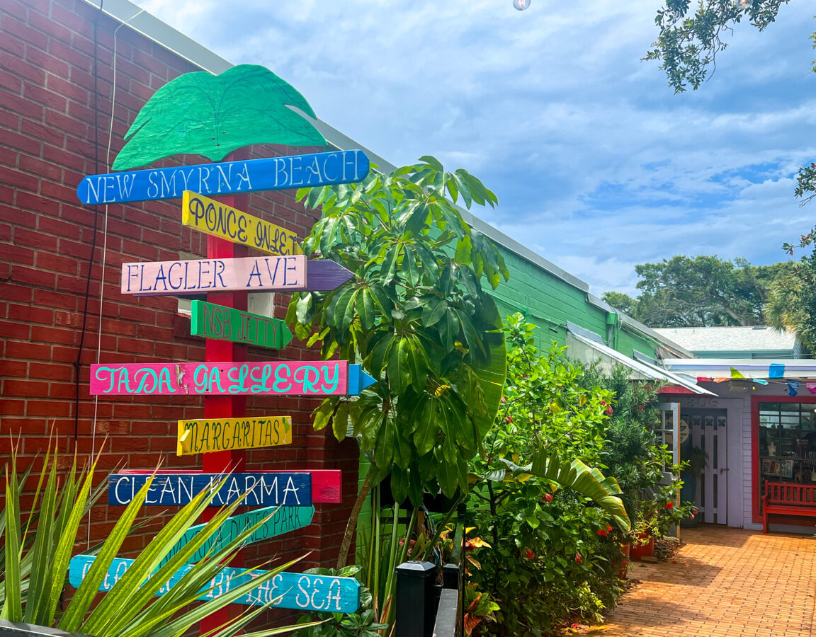 Colorful directional signs in town New Smyrna Beach Florida.