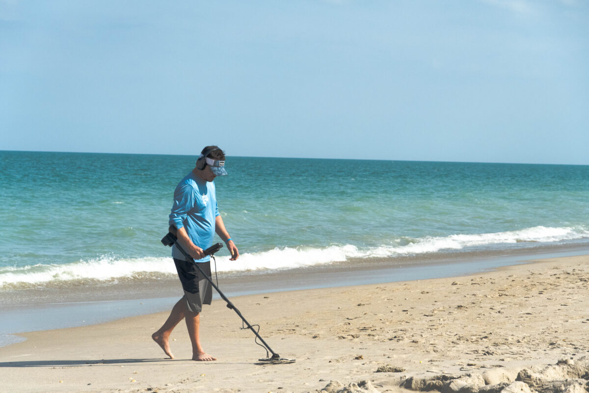 Man metal detecting on beach in Vero Beach, FL