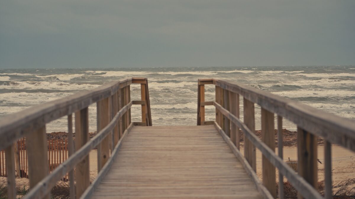 Pier to water, Surfside Beach, Texas.