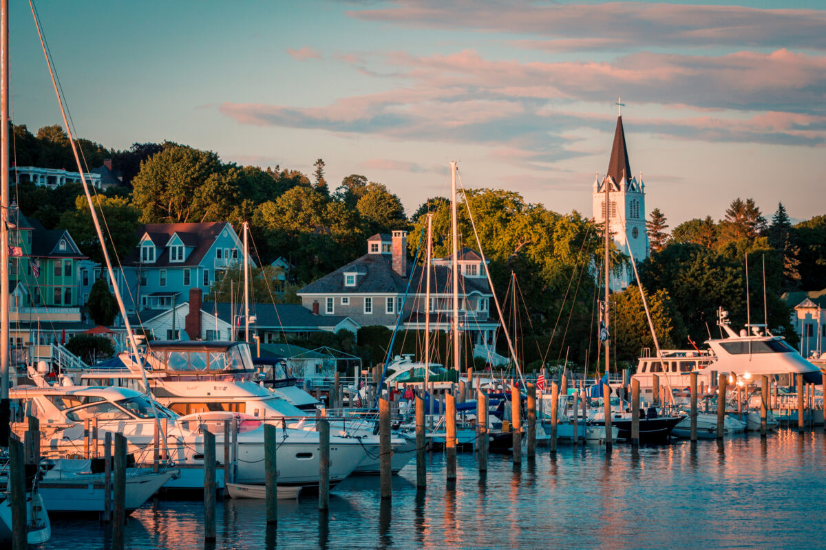 The Marina at Mackinac Island with Saint Anne`s church and the historic Victorian houses a sunset shot from Lake Michigan