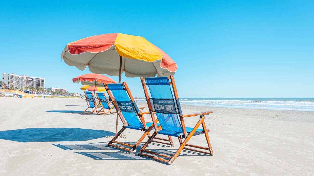 View of colorful beach chairs and umbrellas on Galveston Island Texas.