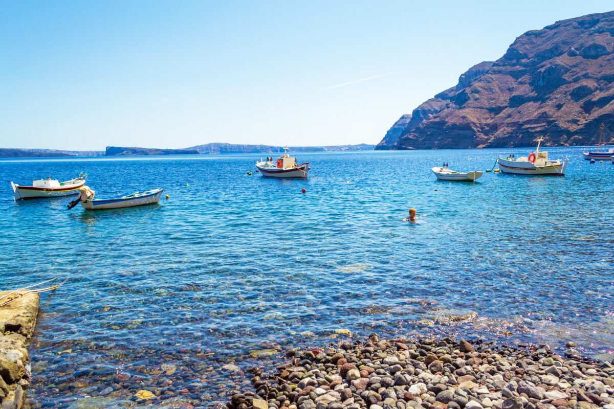 View of Therasia island Korfos pebble beach Greece.