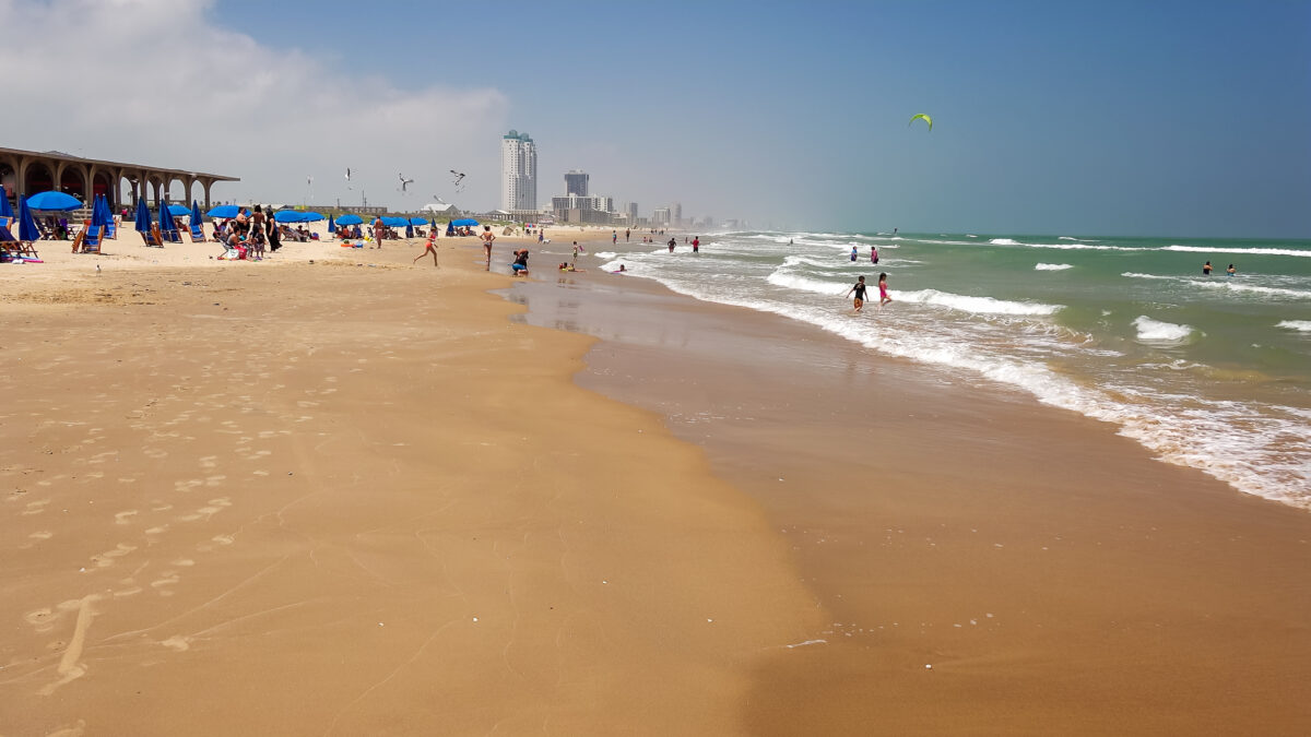 Tourists on South Padre Island Beach in Texas. Tourists on South Padre Island at Isla Blanca County Beach in Texas
