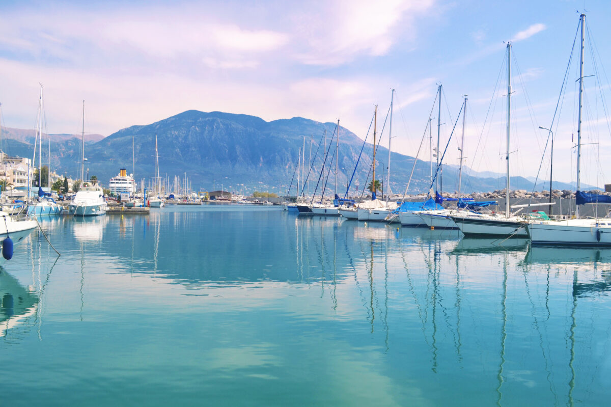 Sailboats reflected on sea at Kalamata port Peloponnese Greece.