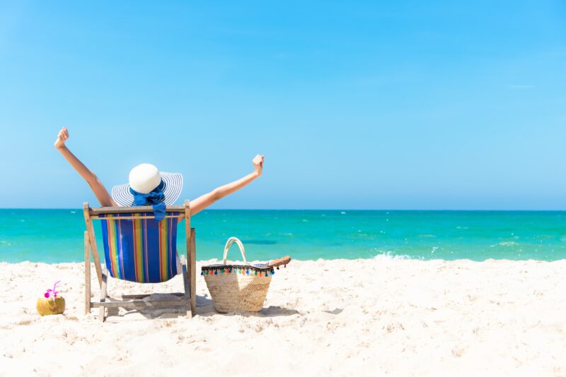 woman relaxing and happy on beach chair
