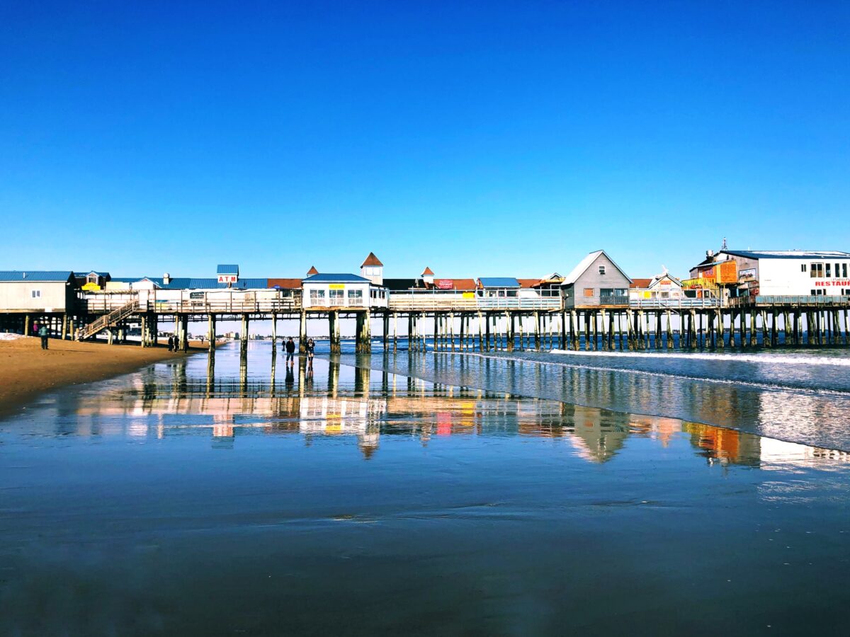 A wooden pier on Old Orchard Beach contains many other tourist businesses by the sea located on the inner side of Saco Bay on the Atlantic Ocean in York County, Maine, United States.