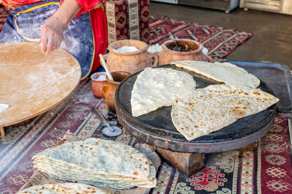 Woman making Azerbaijan Qutab with Greens.