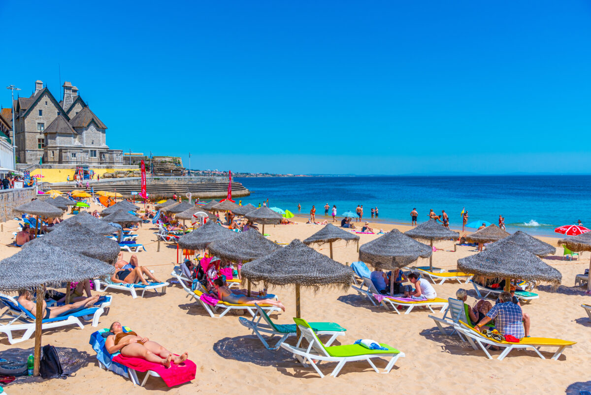 Palace of duques of palmela viewed behind Duquesa beach in Cascais, Portugal.