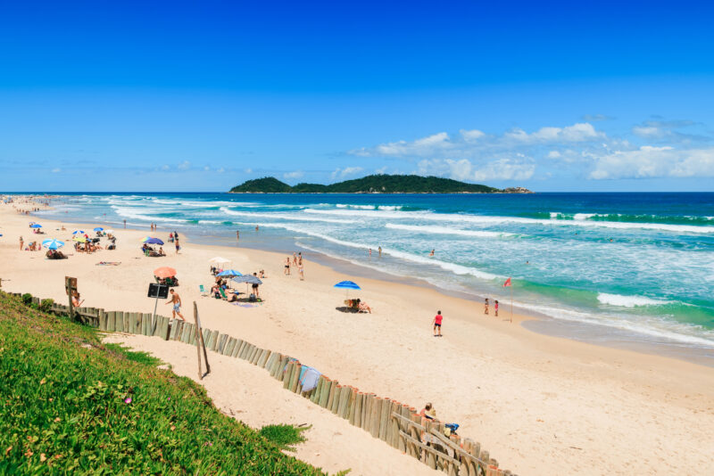 Florianopolis, Brazil. Holiday beach with people and blue ocean in Brazil. Morro das Pedras beach in. Morro das Pedras beach in Florianopolis.
