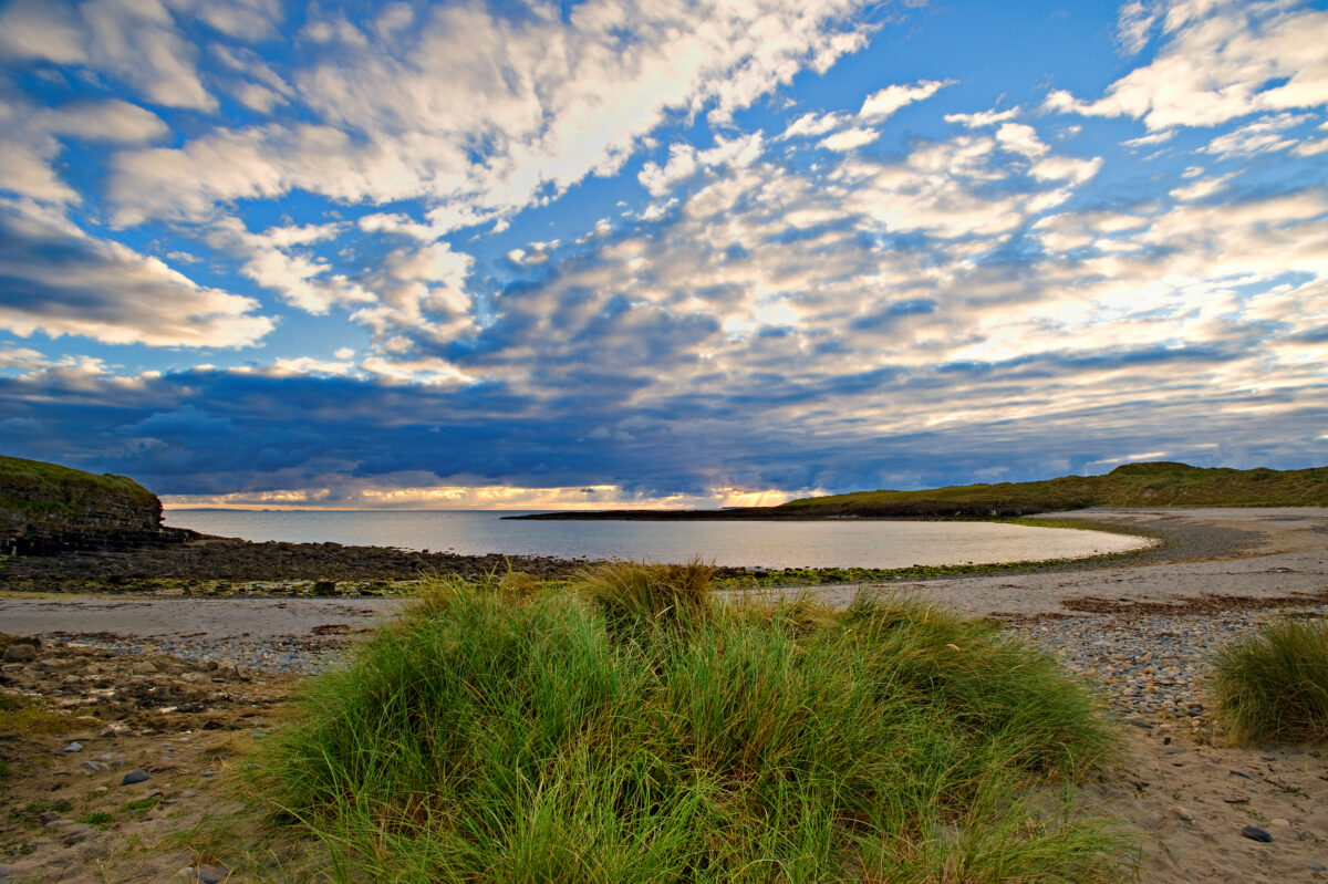 Evening sun lights beach and sky at Streedagh, Co. Sligo, Ireland.