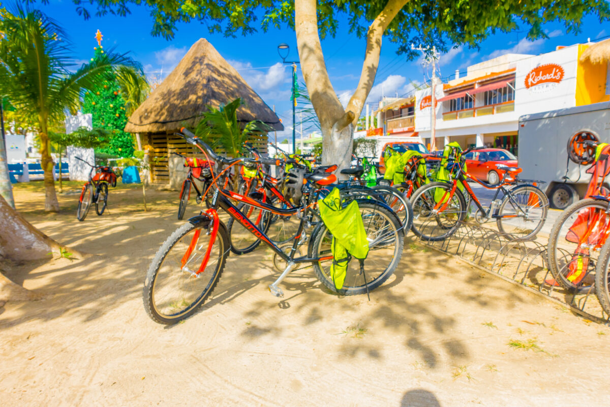 Outdoor view of many bicycles parked in a row woin a rent bikes in the streets of Puerto Morelos, Yucatan Peninsula, Mexico, south of Cancun.