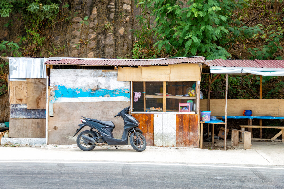 Motorcycle scooter parked on the side of the road Labuan Bajo, Indonesia.