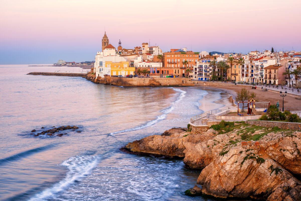 Sand beach and historical Old Town in mediterranean resort Sitges, Spain.