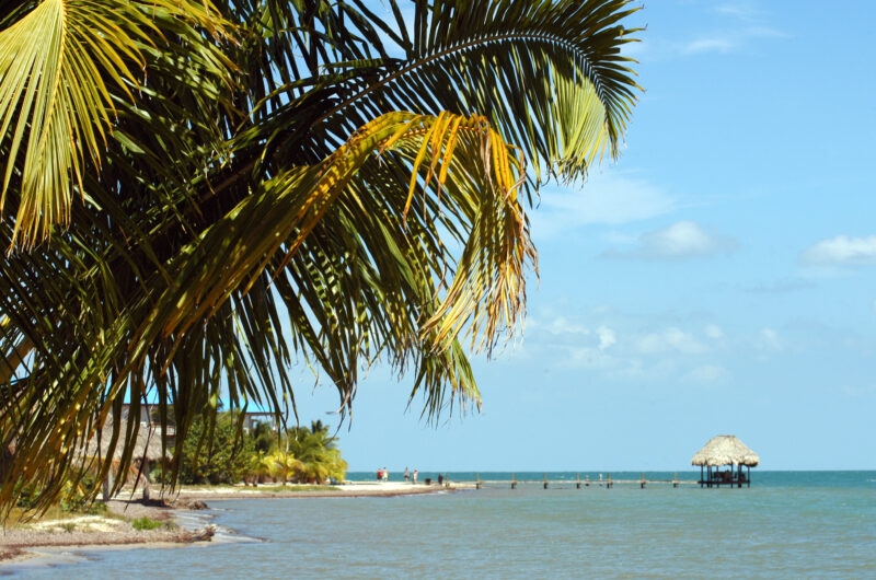 Belize, peninsula Placencia. Placencia, Belize Straw hut on clear sea.