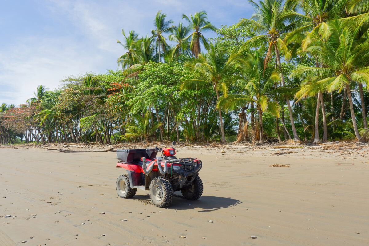 Red all-terrain quad bike on the beach of Costa Rica.