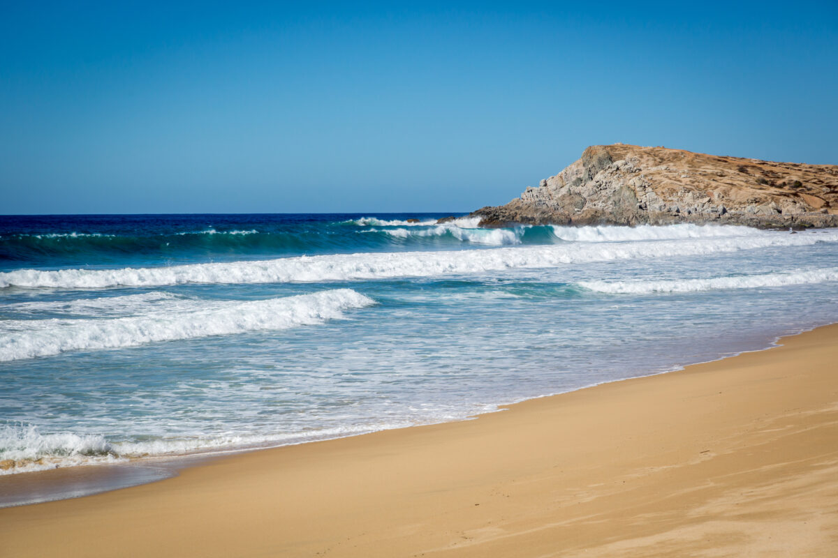 Few people enjoying the early day in Todos Santos beach in Baja California, Mexico