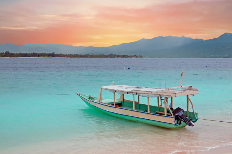 Traditional boat on Gili Meno island beach, Indonesia Asia at sunset.