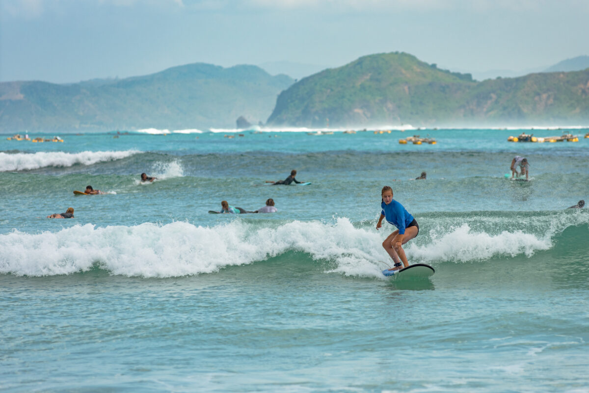 Pantau Mawun, Lombok, Indonesia. Young woman learns to surf.