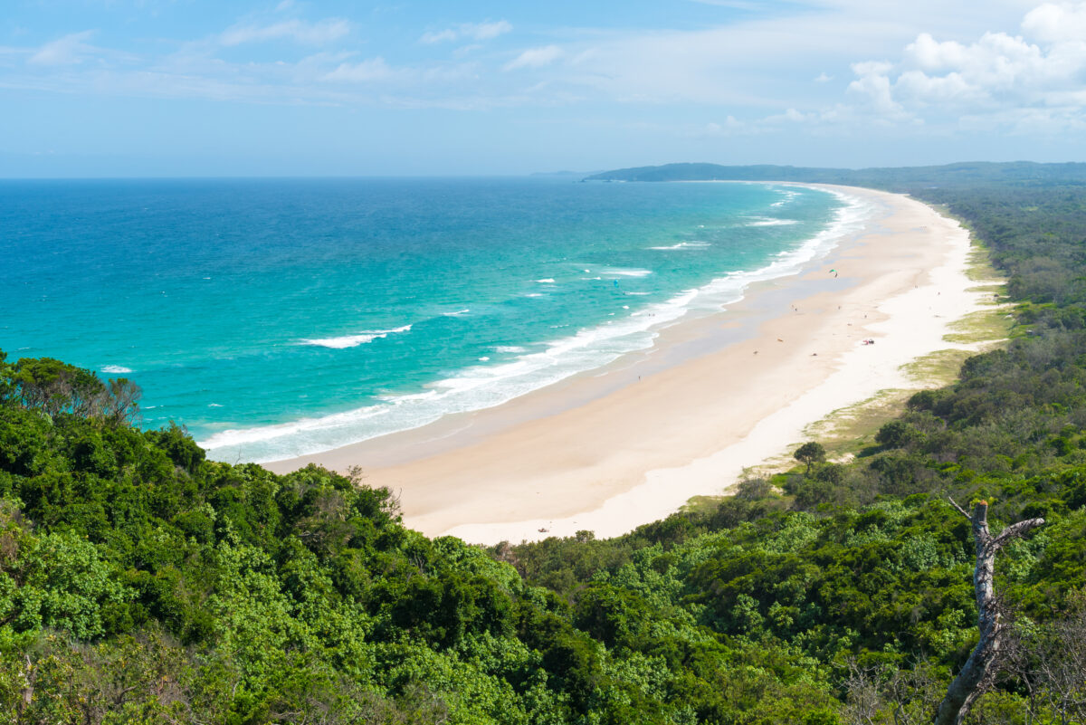 View over Tallow Beach with turquoise waters in Arakwai National Park at Byron Bay, NSW, Australia