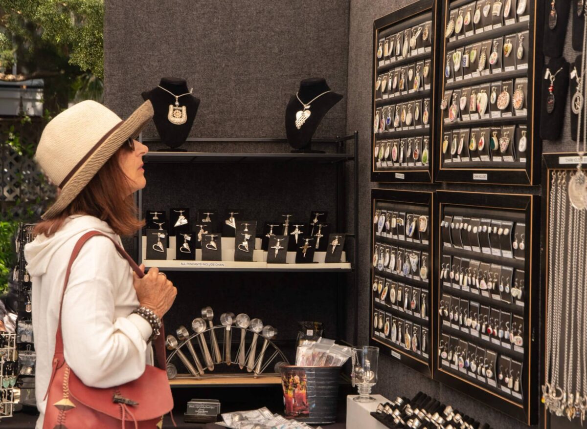 woman looking at jewelry at Old Florida Celebration of the Arts