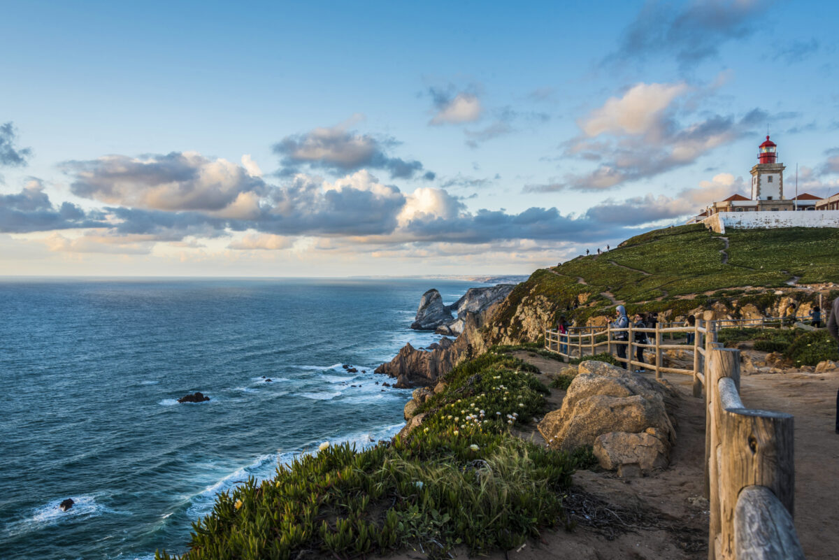 The Atlantic coast north of Cabo da Roca with its lighthouse at sunset